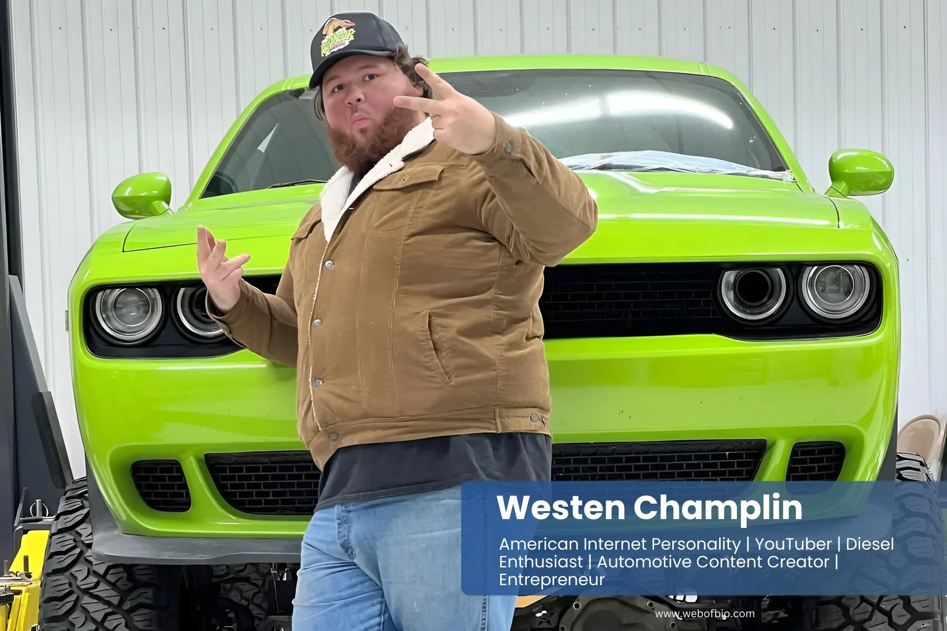 Westen Champlin is standing next to a green Dodge muscle car.