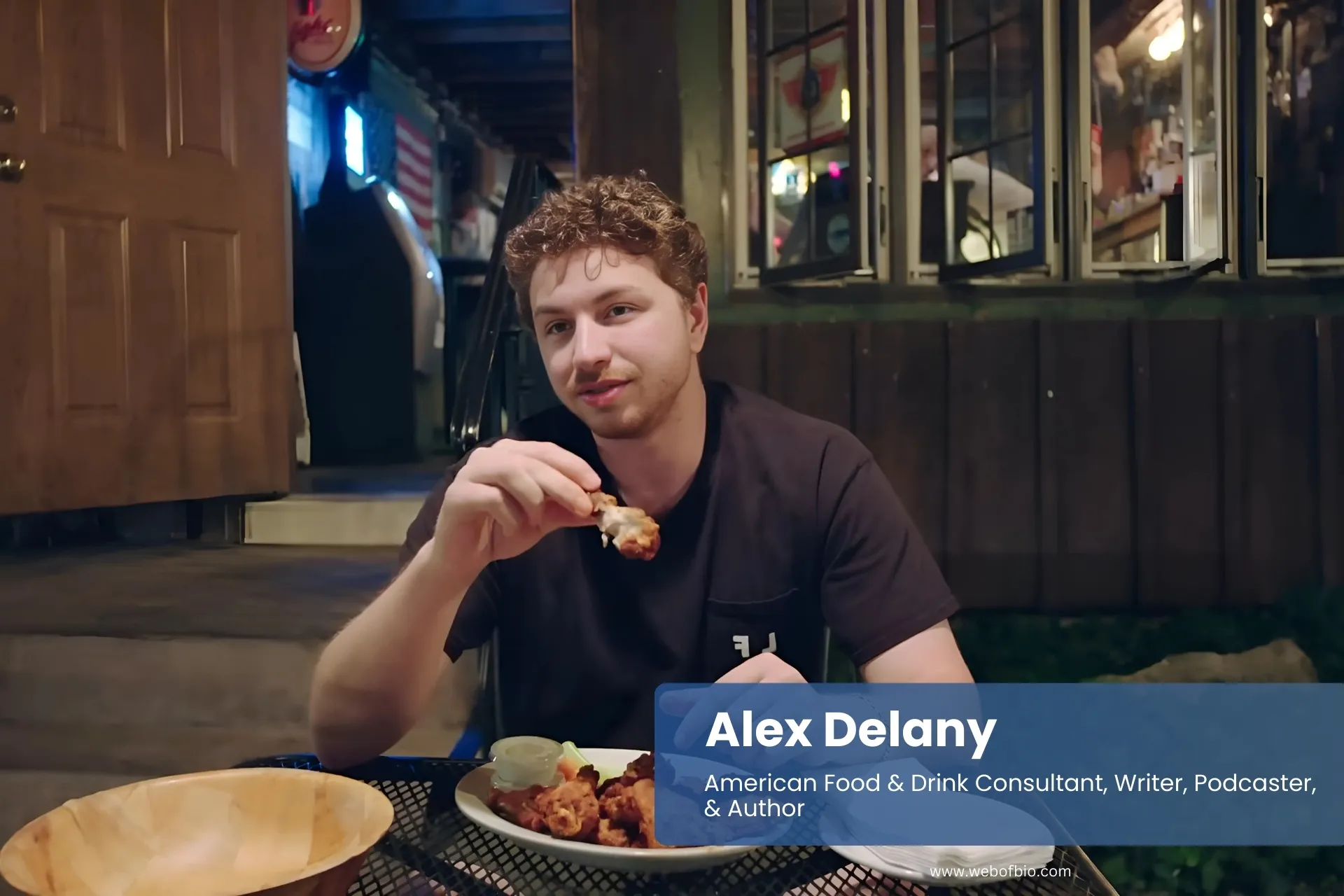 Alex Delany eating at restaurant table.
