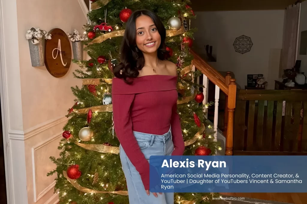 Alexis Ryan jeans and red top by Christmas tree.