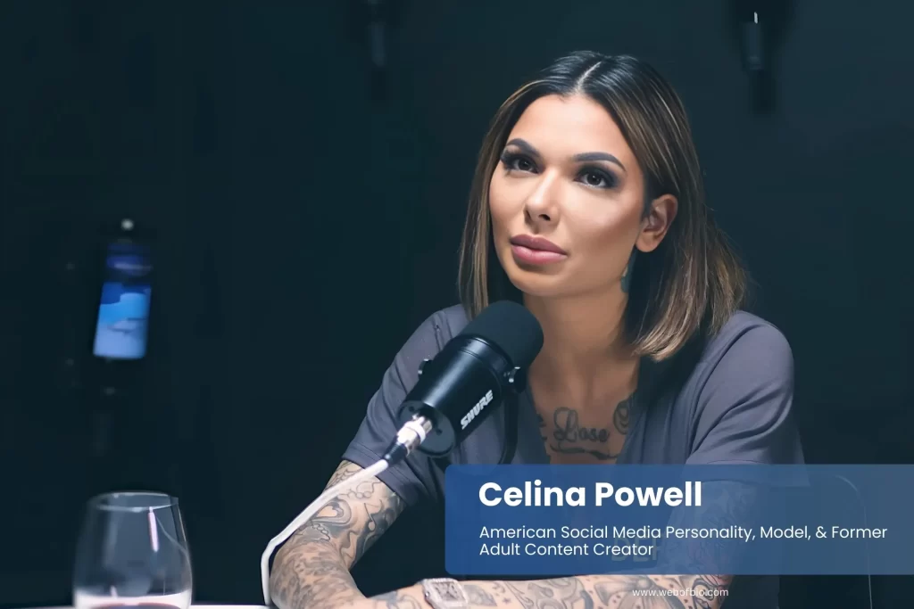 Celina Powell seated at table with microphone.