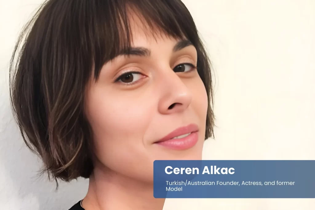 Ceren Alkac short haircut, black top, posing.