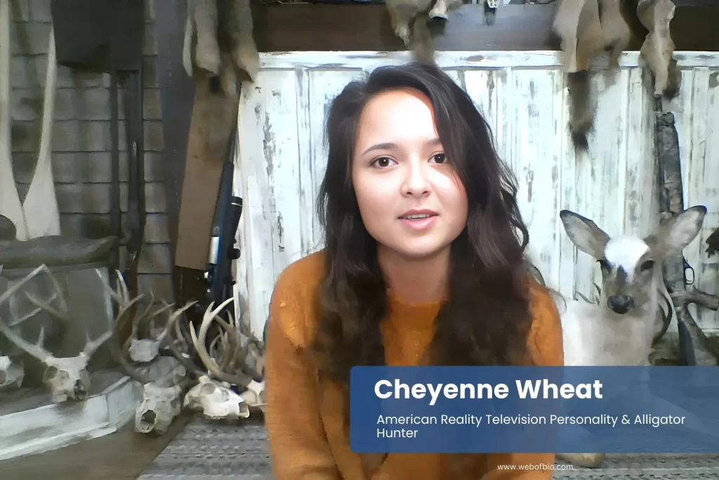 Cheyenne Wheat in front of wall with deer heads.