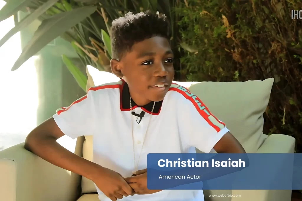 Christian Isaiah sitting on couch.