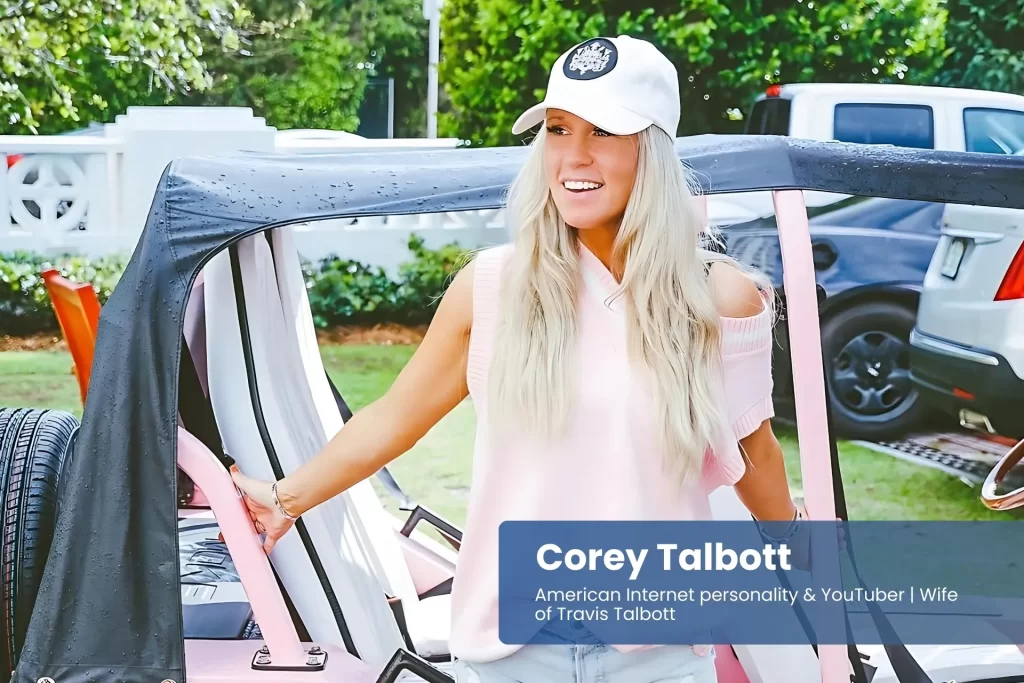 Corey Talbott beside pink jeep, pink hat and shorts.