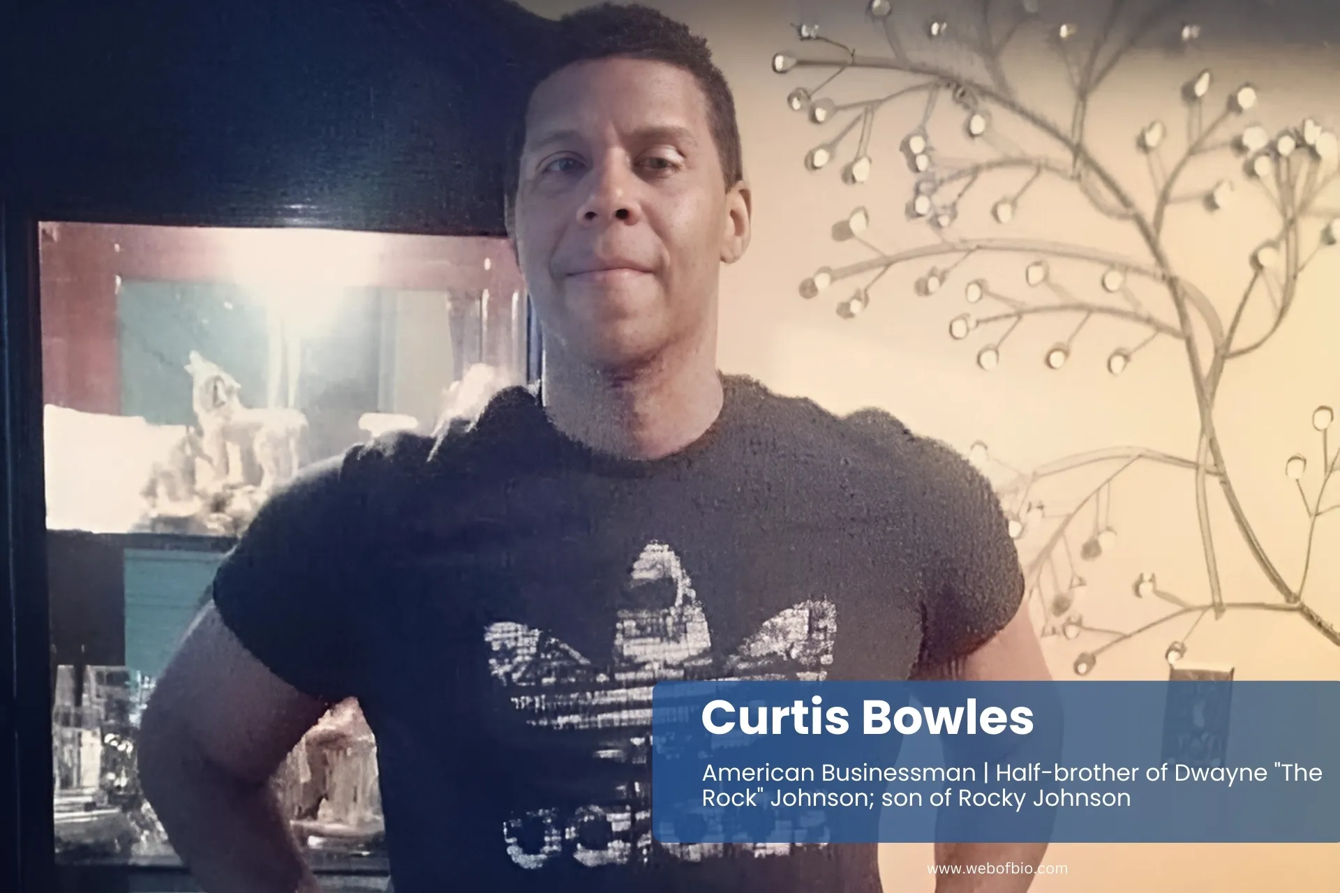 Curtis Bowles in t-shirt, in front of mirror.