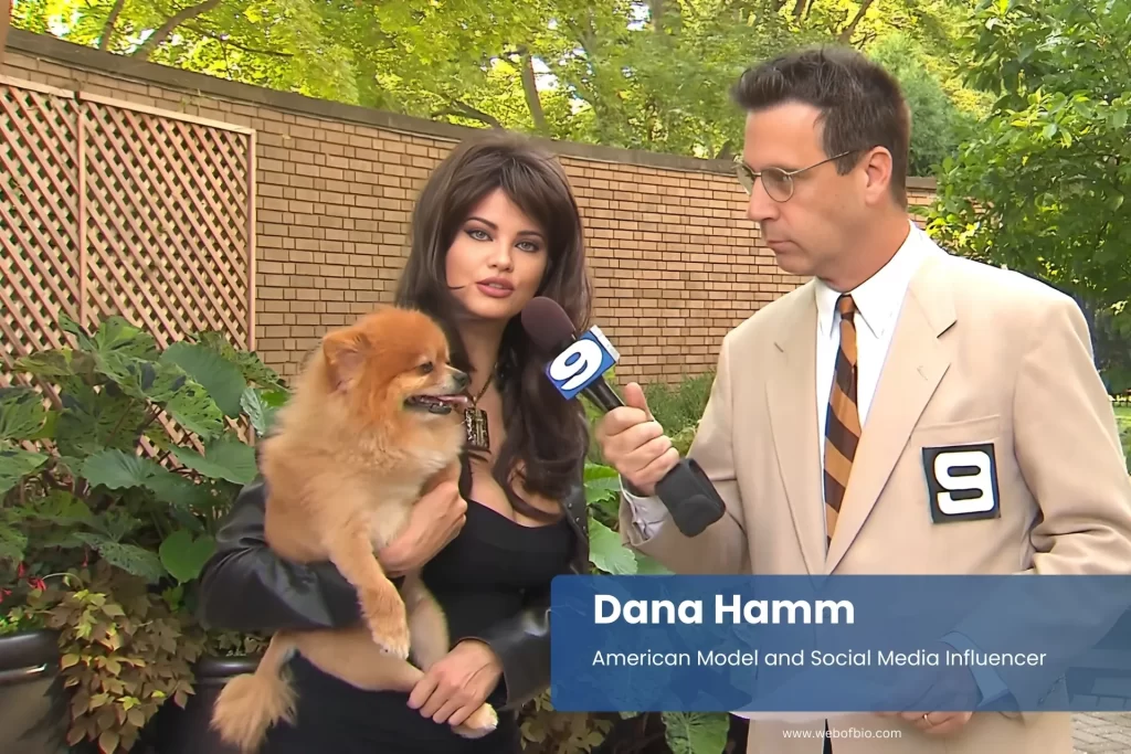 Dana Hamm holding small dog.
