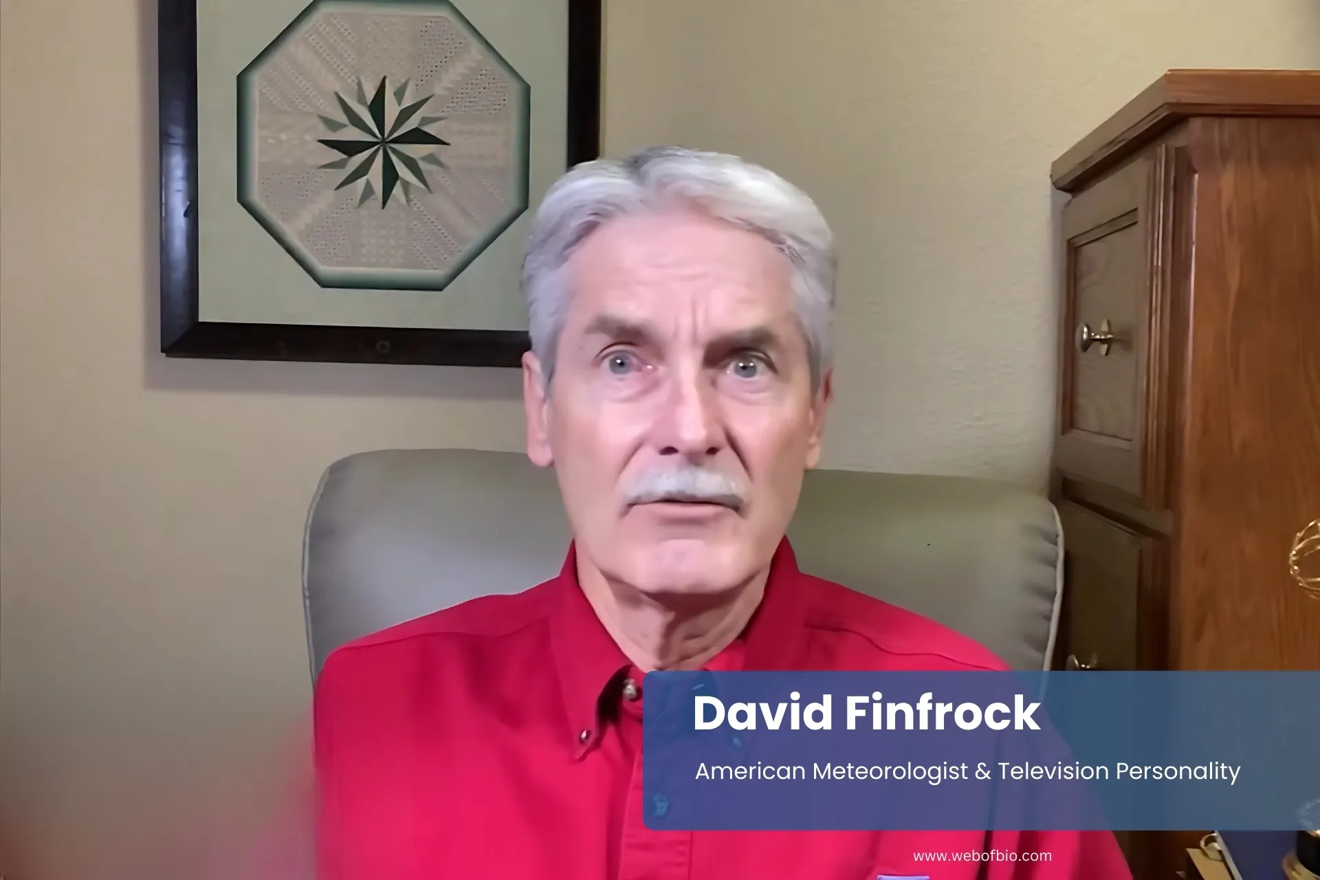 David Finfrock pink shirt, seated at desk.