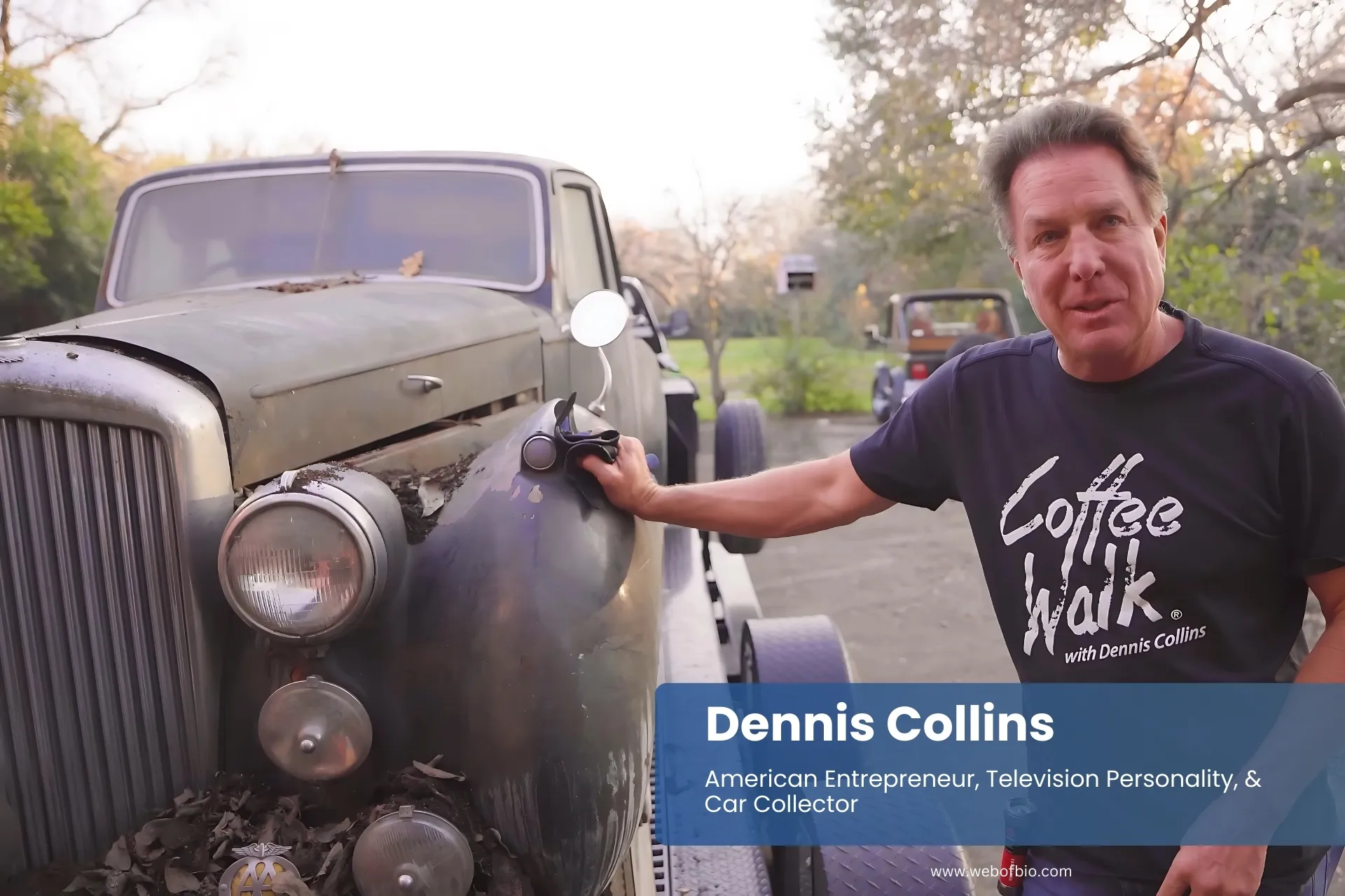 Dennis Collins beside vintage car.