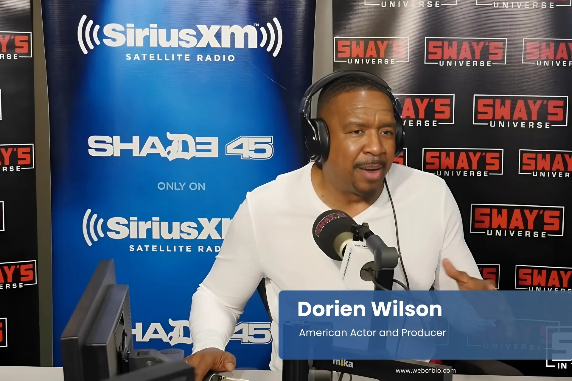 Dorien Wilson white shirt, at microphone.