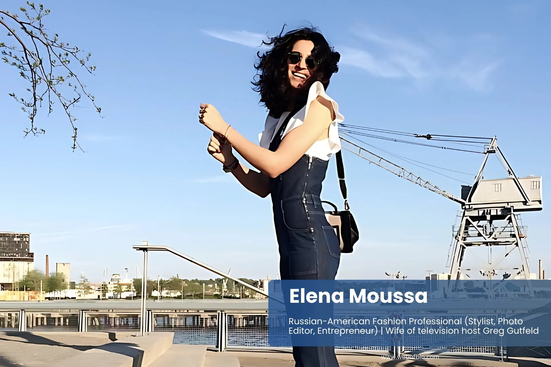 Elena Moussa denim overalls on sidewalk, posing.