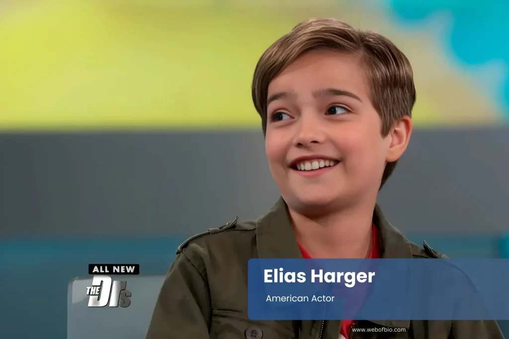 Elias Harger smiling, sitting on television.