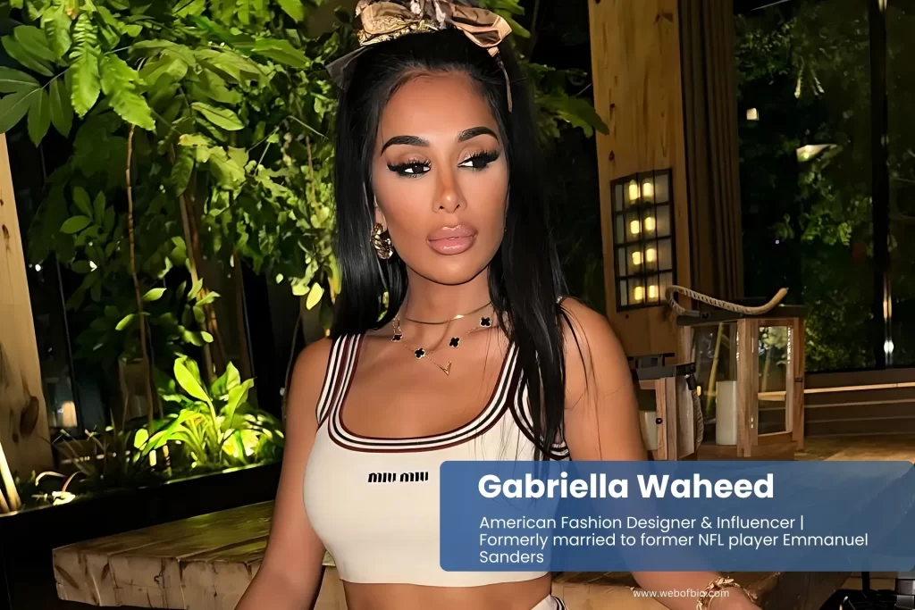 Gabriella Waheed white crop top and shorts, sitting.