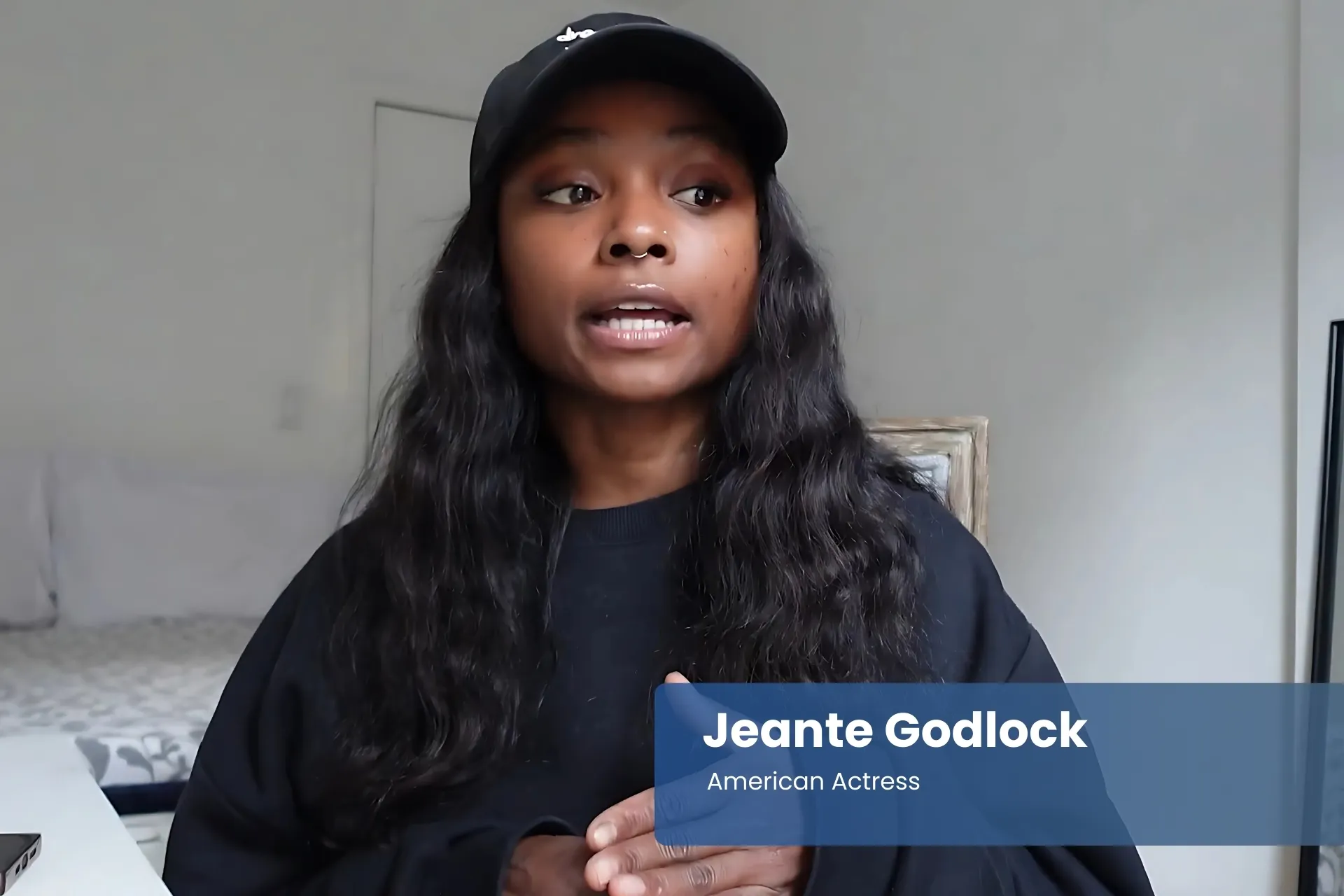 Jeante Godlock black sweatshirt and hat, in conversation.