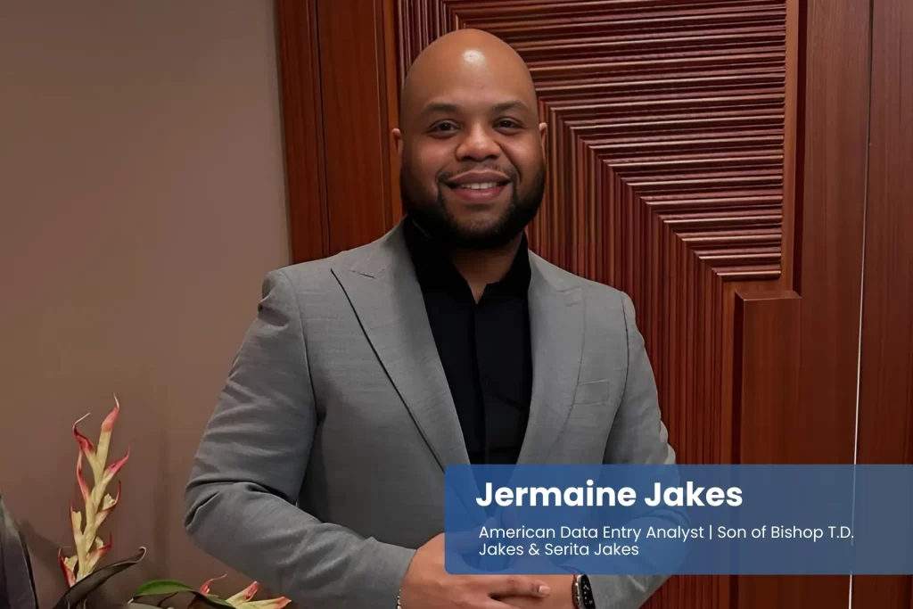 Jermaine Jakes in suit, standing by closed door.