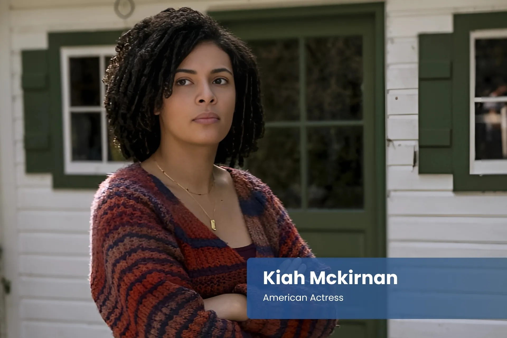 Kiah Mckirnan standing in front of house.