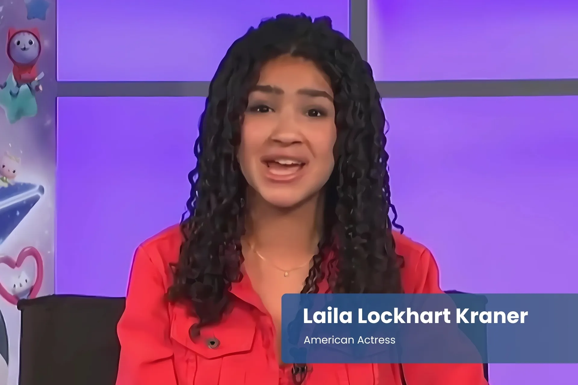 Laila Lockhart Kraner red shirt on couch.