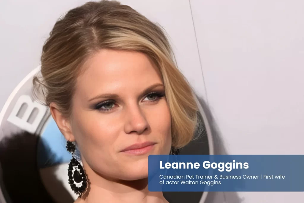 Leanne Goggins black dress and earrings, posing.