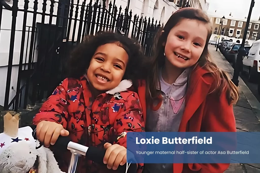 Loxie Butterfield riding bike with sister.