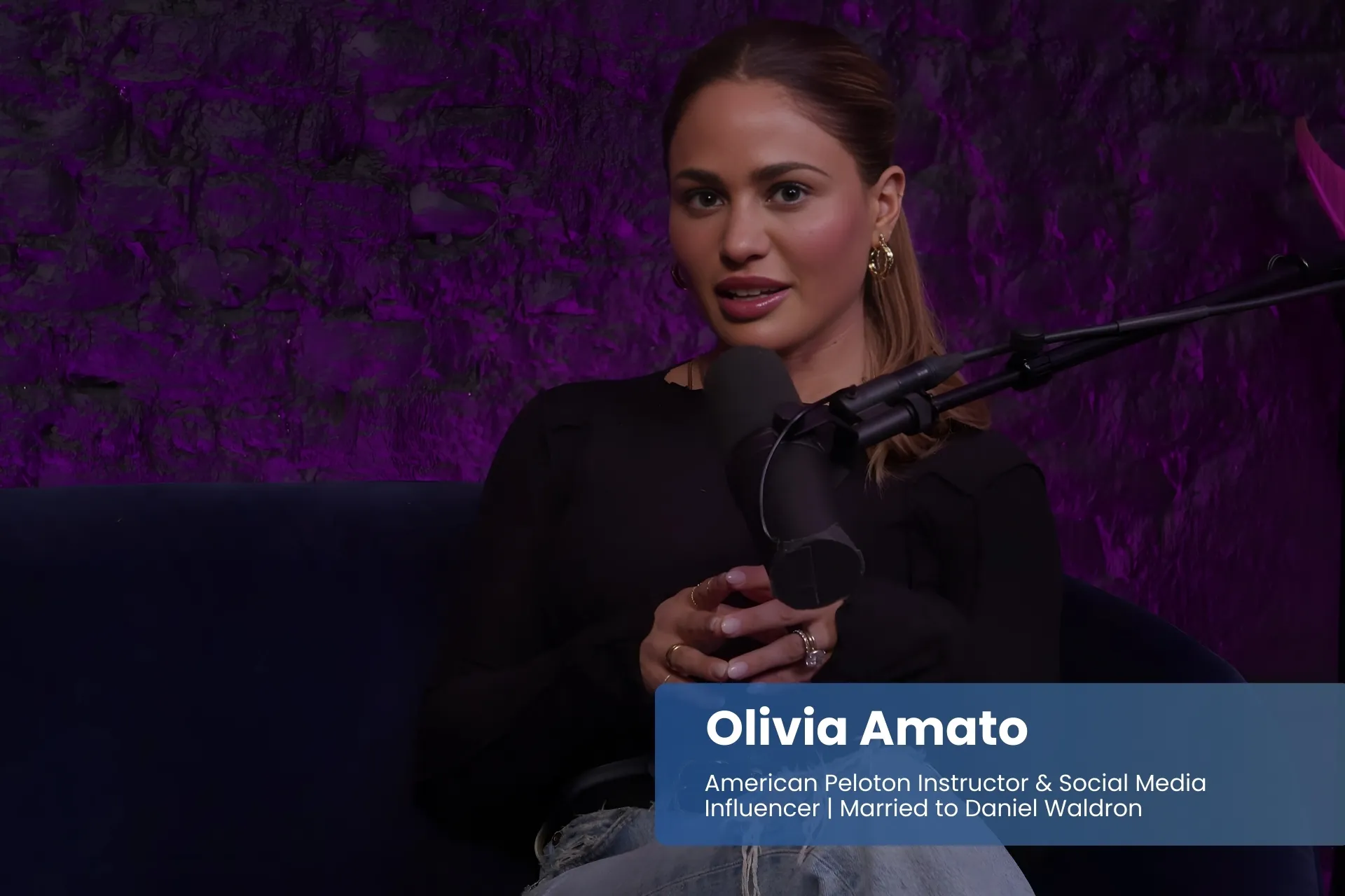 Olivia Amato on couch with microphone.