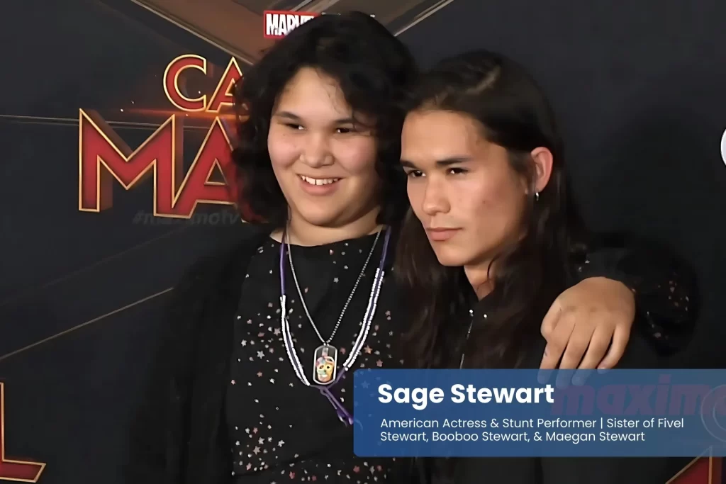 Sage and Booboo Stewart smiling at movie premiere.