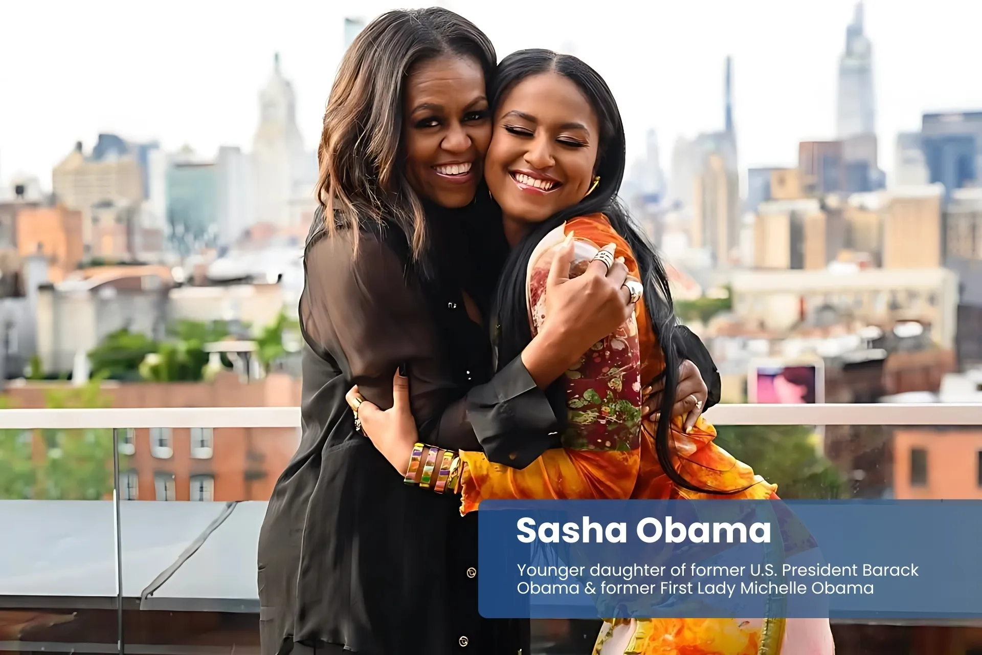 Sasha and Michelle Obama smiling on rooftop, NYC view.
