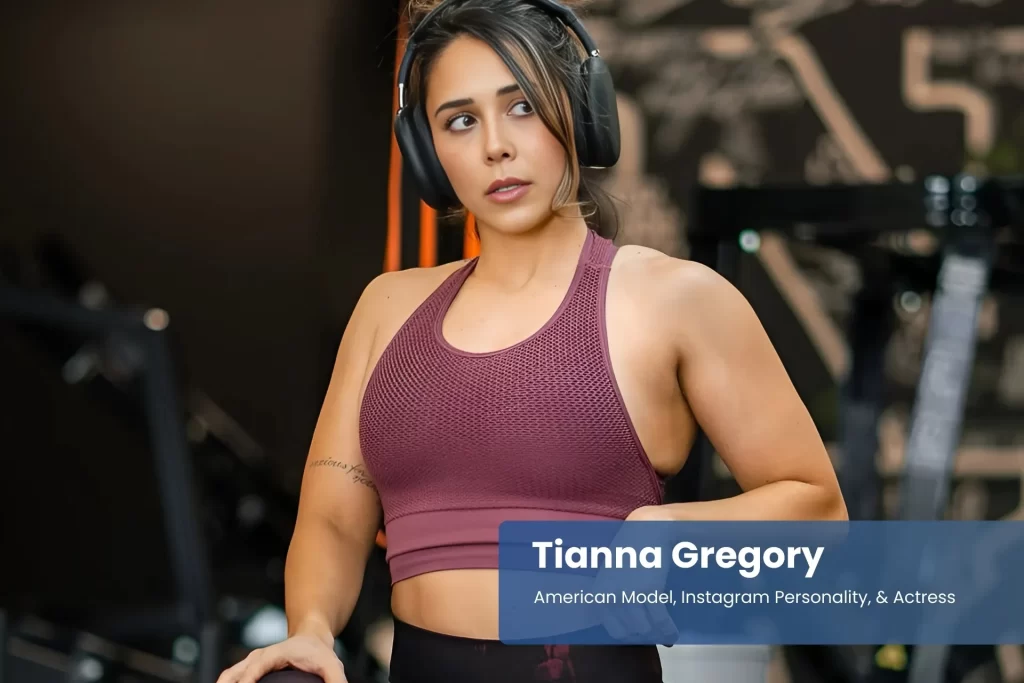 Tianna Gregory purple sports bra and leggings, posing.