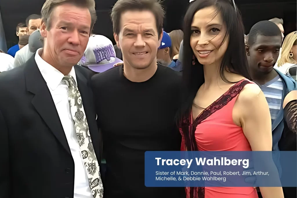 Tracey Wahlberg and her brothers smiling together.