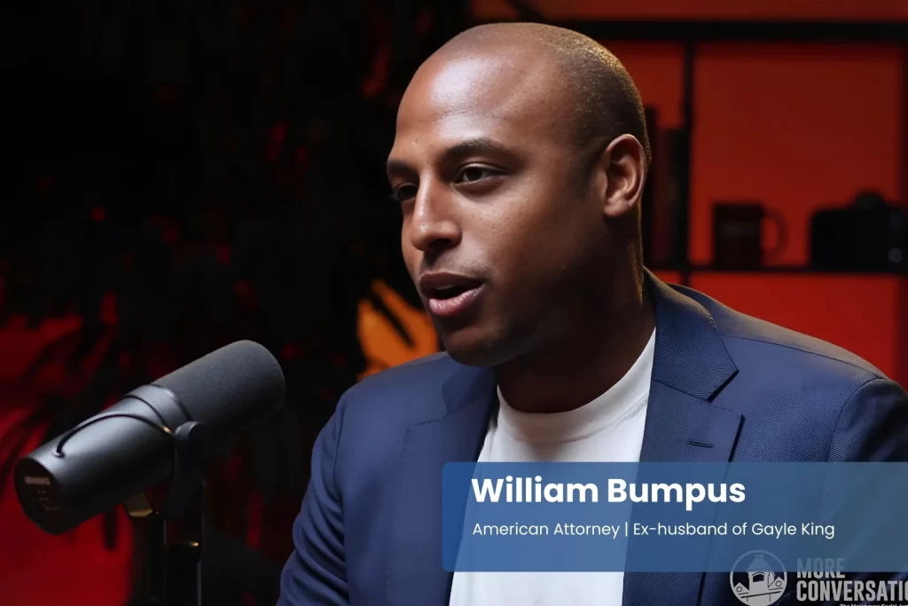 William Bumpus in suit, speaking into microphone.