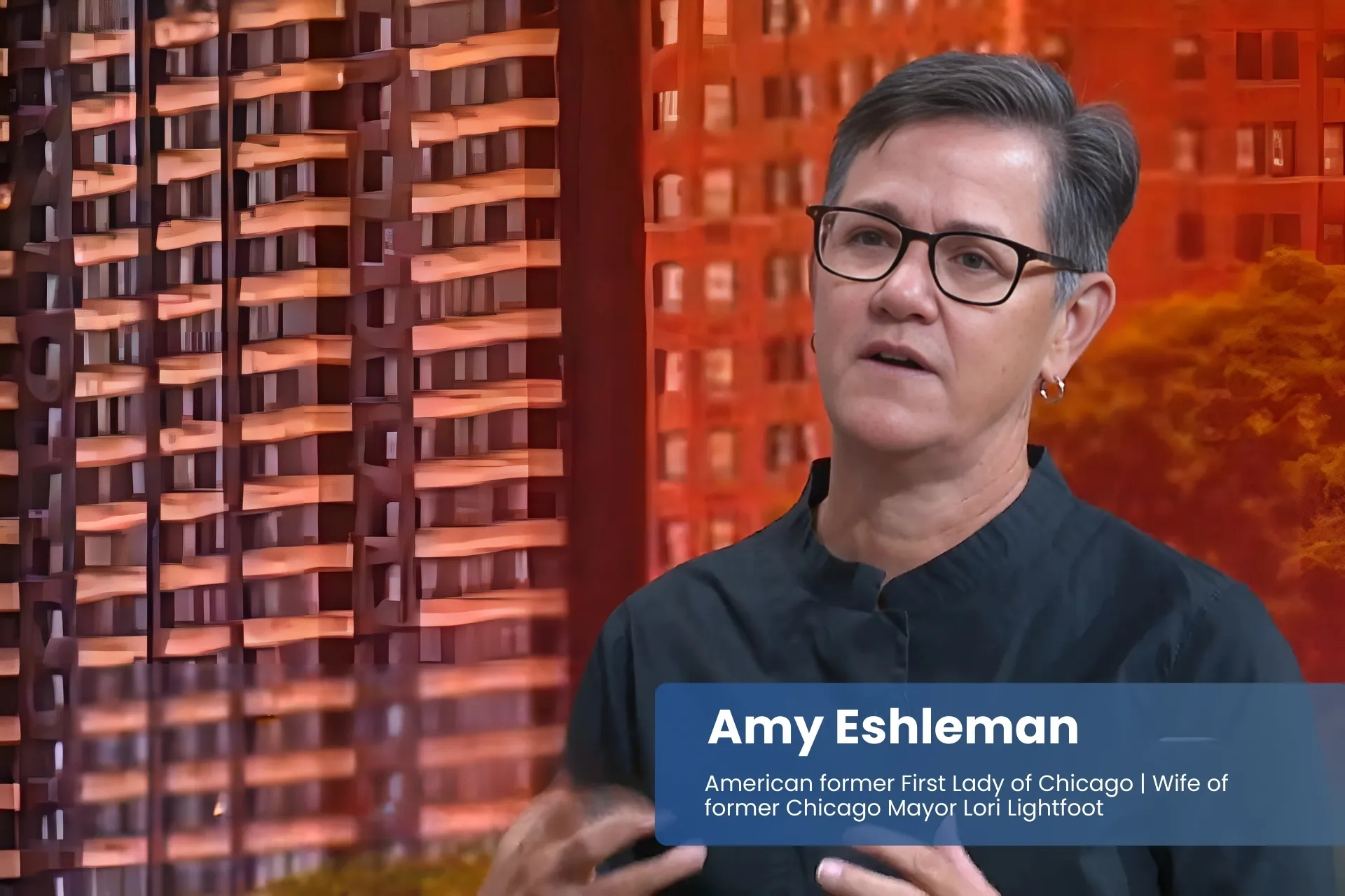 Amy Eshleman with glasses, talking to news anchor