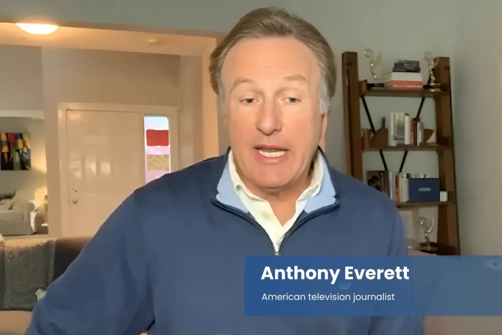 Anthony Everett blue sweater, speaking on television