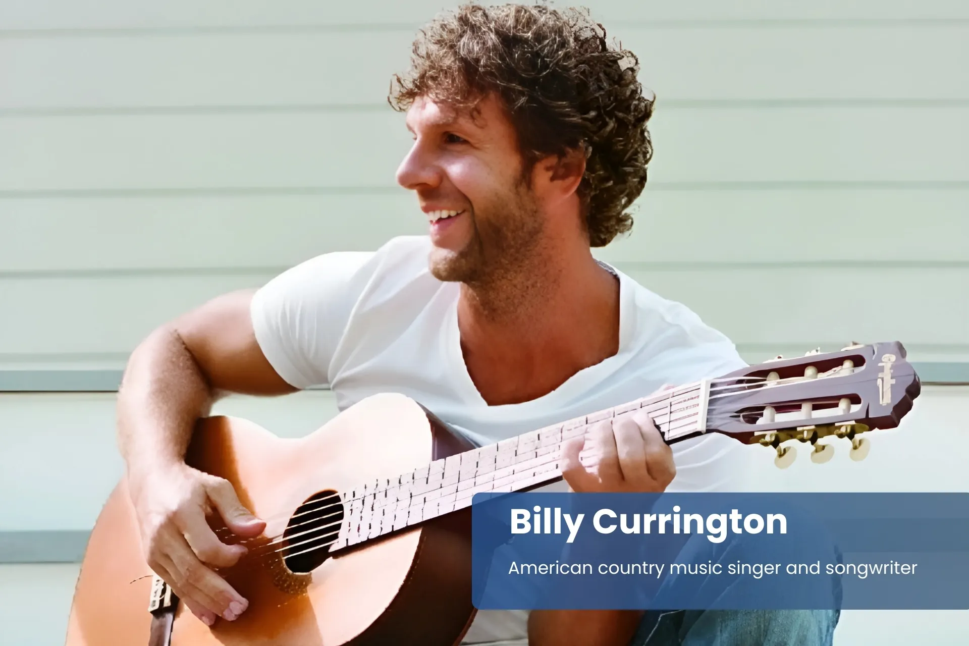 Billy Currington sitting on steps with acoustic guitar
