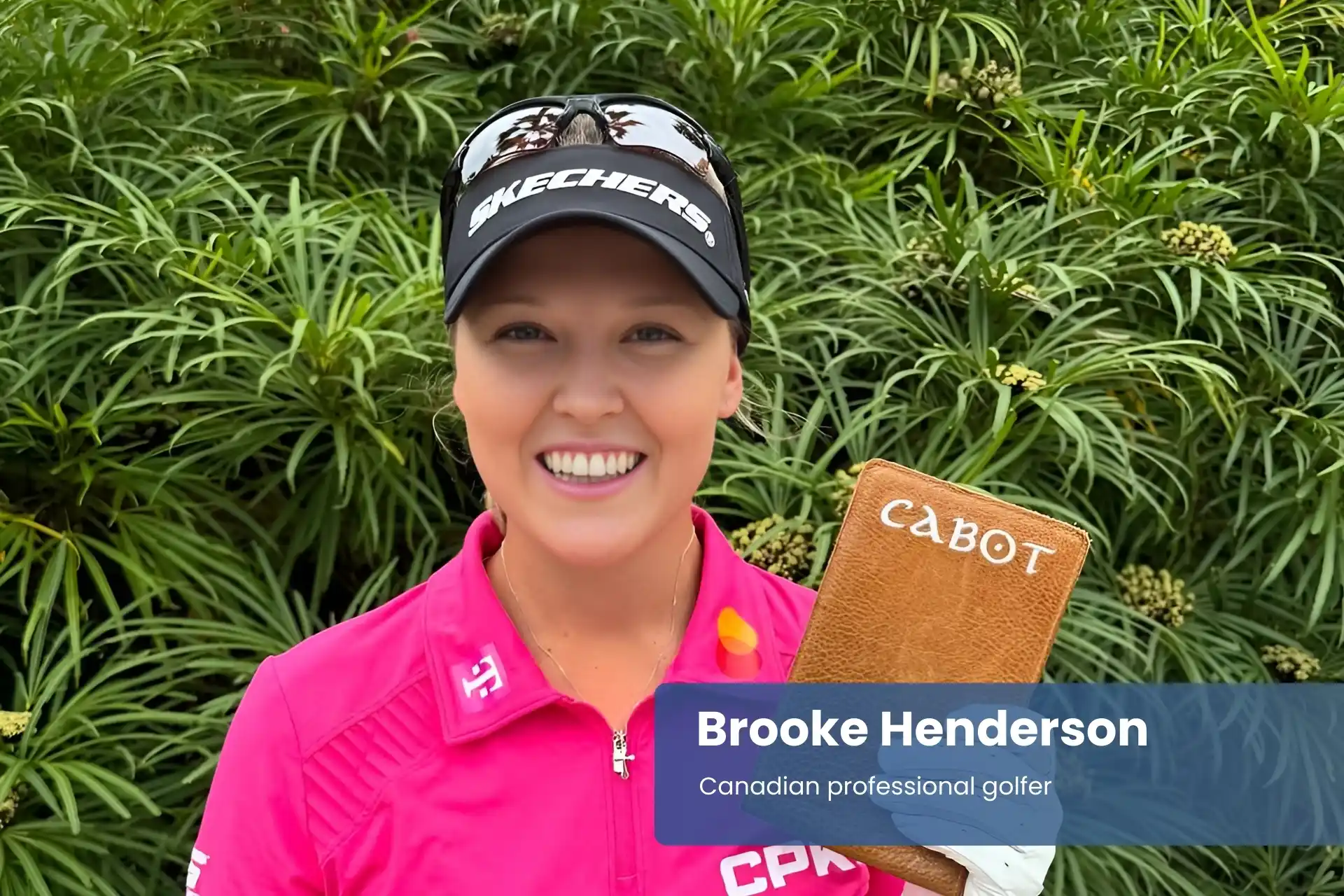 Brooke Henderson pink shirt, holding book