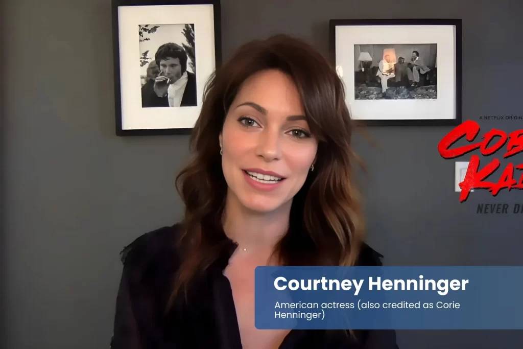 Courtney Henninger seated by wall of framed pictures