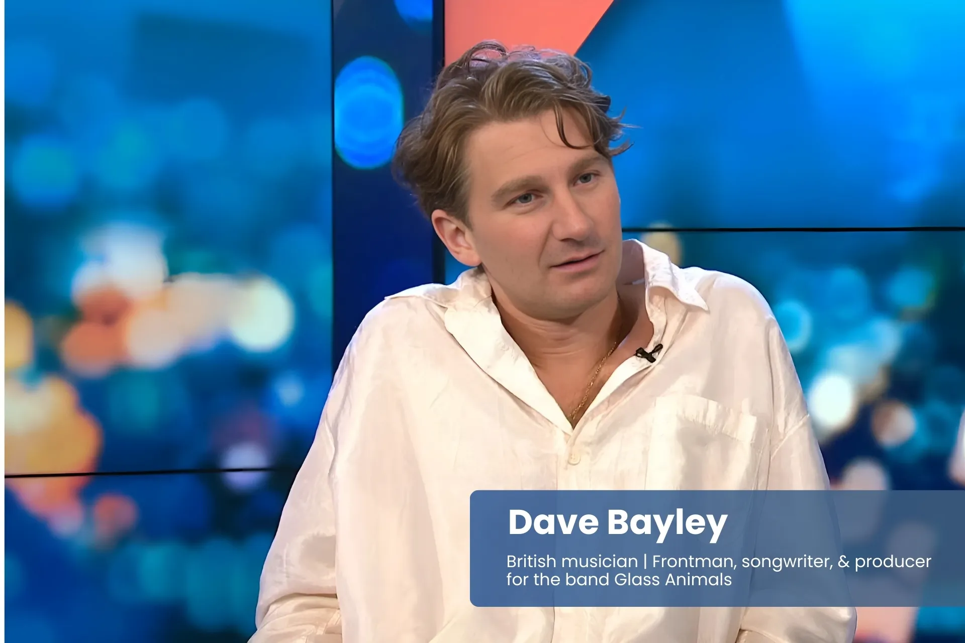 Dave Bayley white shirt, sitting on couch