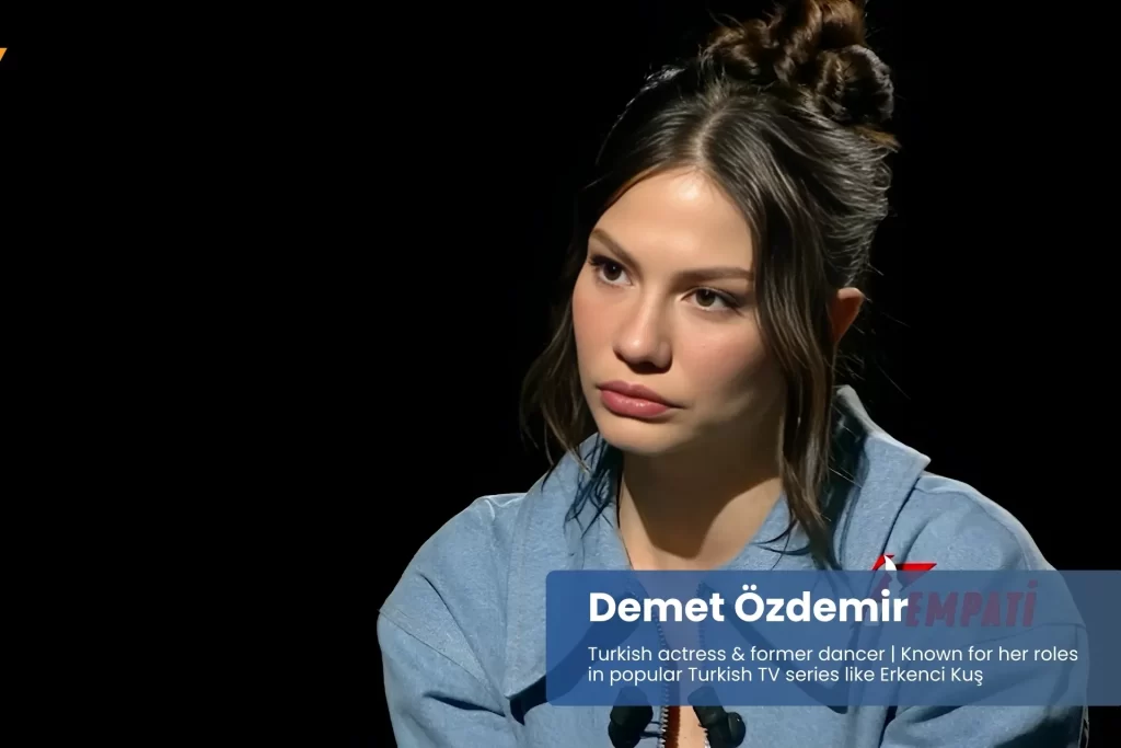 Demet ozdemir blue shirt, seated