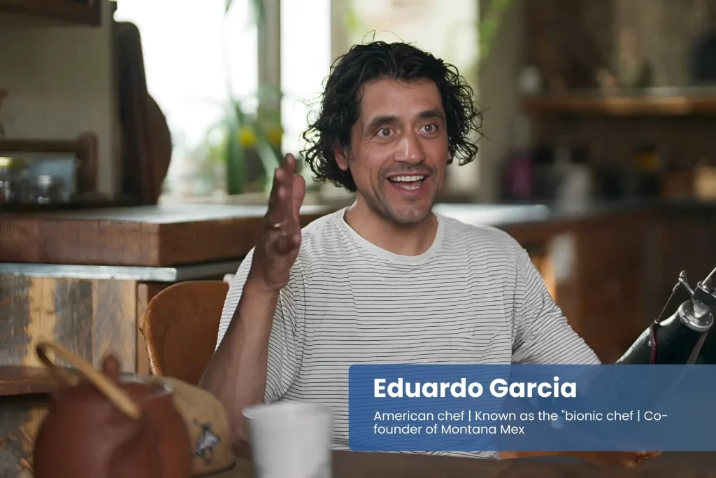 Eduardo Garcia at table, showing prosthetic arm