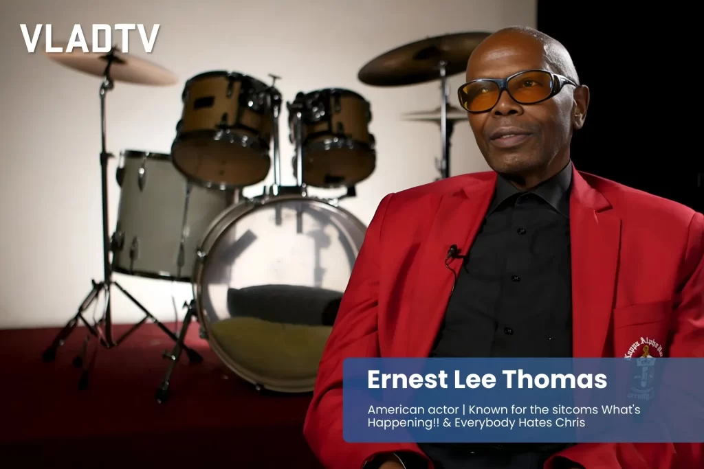 Ernest Lee Thomas red jacket, in front of drum set