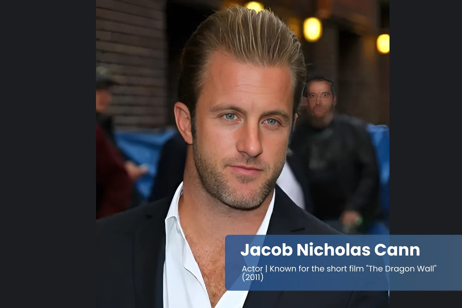 Jacob Nicholas Caan suit and white shirt, standing