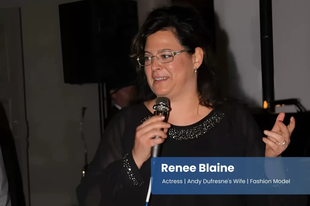 Renee Blaine black dress, holding microphone